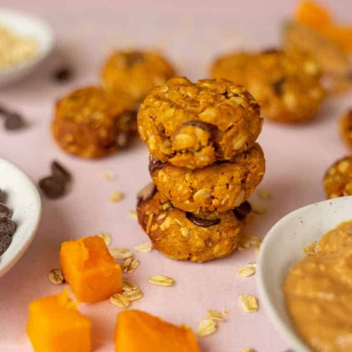 a stack of pumpkin peanut butter cookies with chocolate chips.
