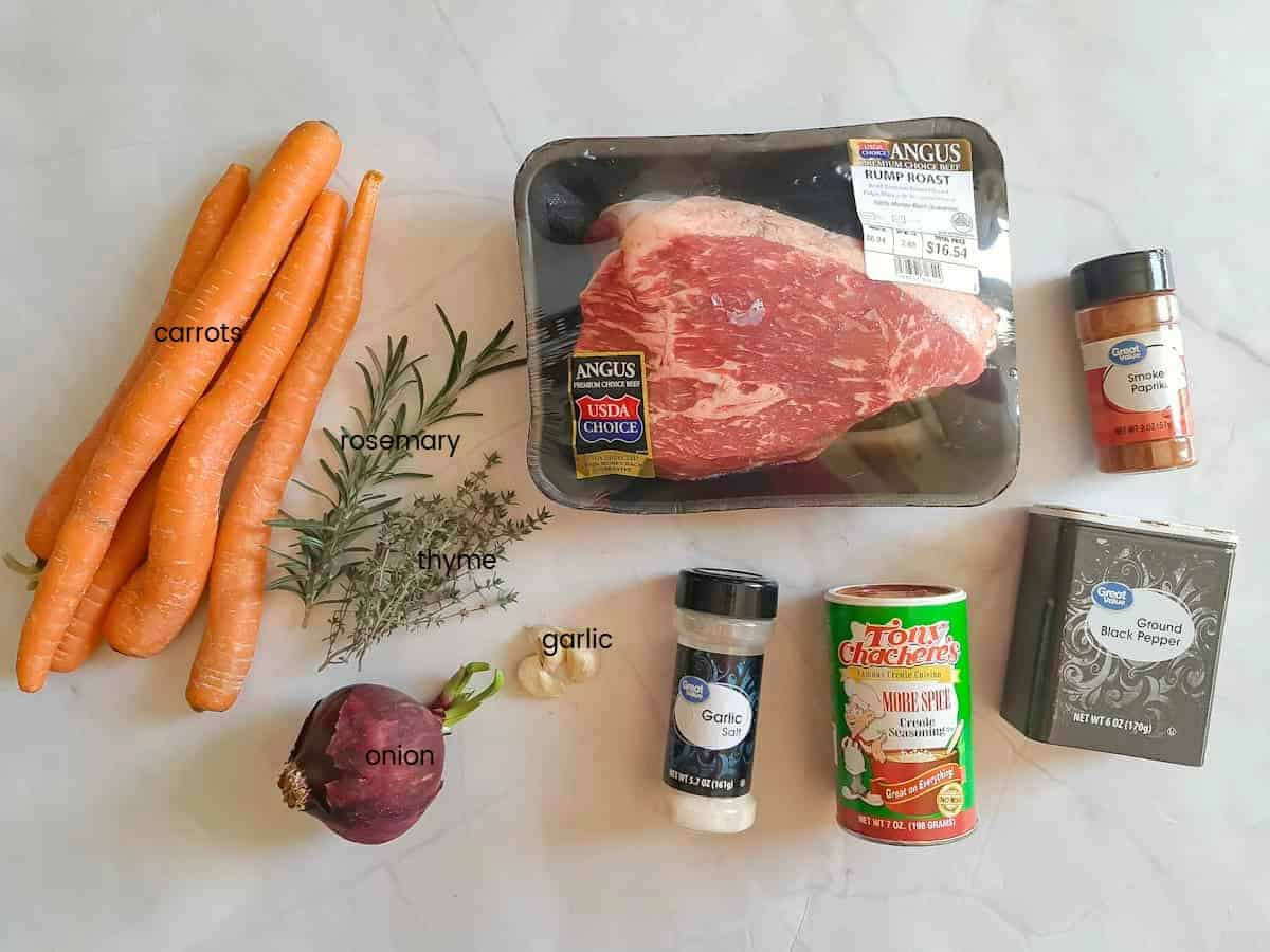 Ingredients: rump roast, onion, garlic, carrots, thyme, rosemary, garlic salt, Tony's seasoning, black pepper, and paprika.