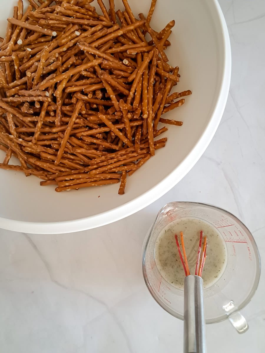 bowl with pretzels and glass pitcher of seasonings.