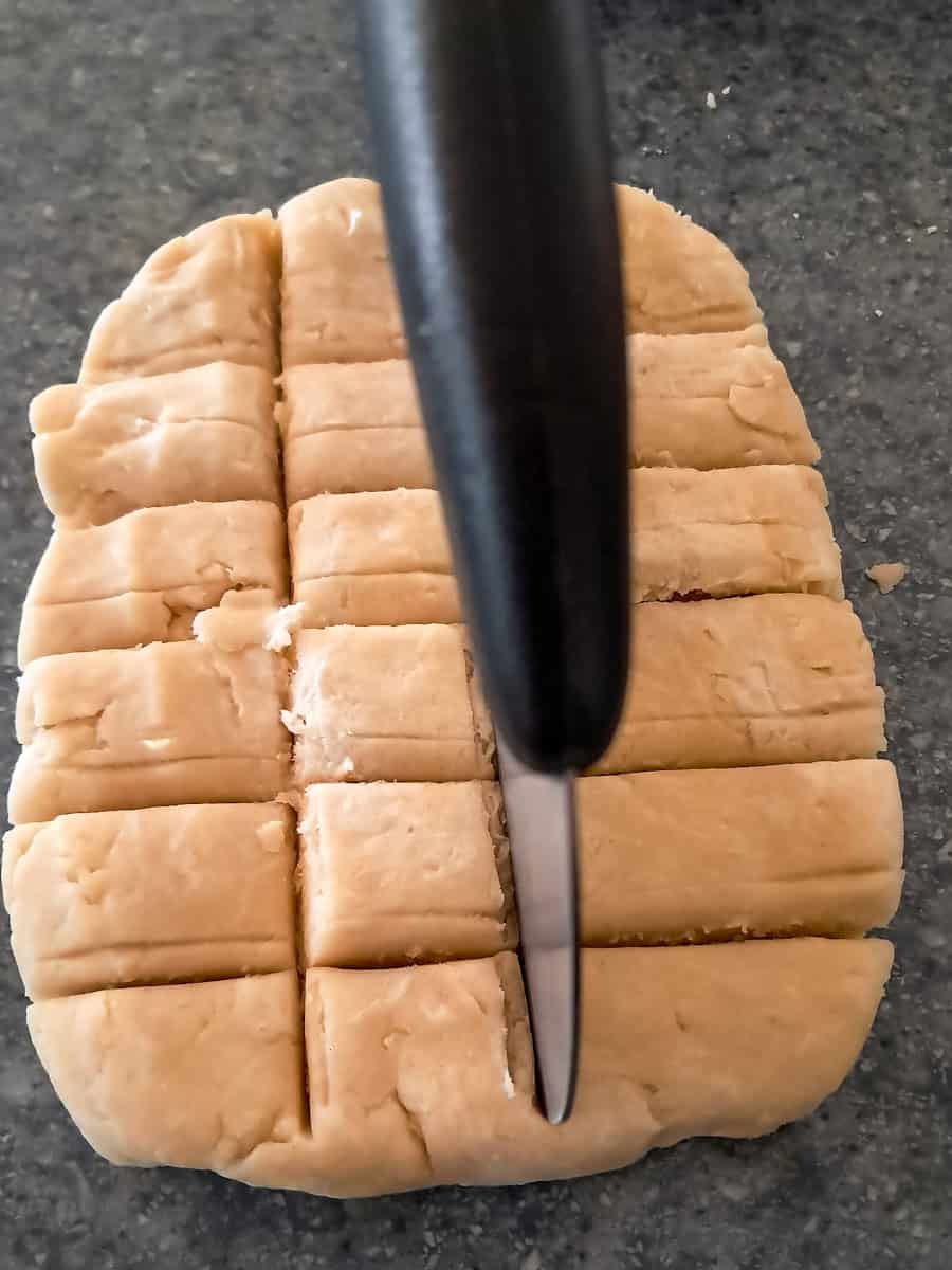 cutting dough into pieces to divide.