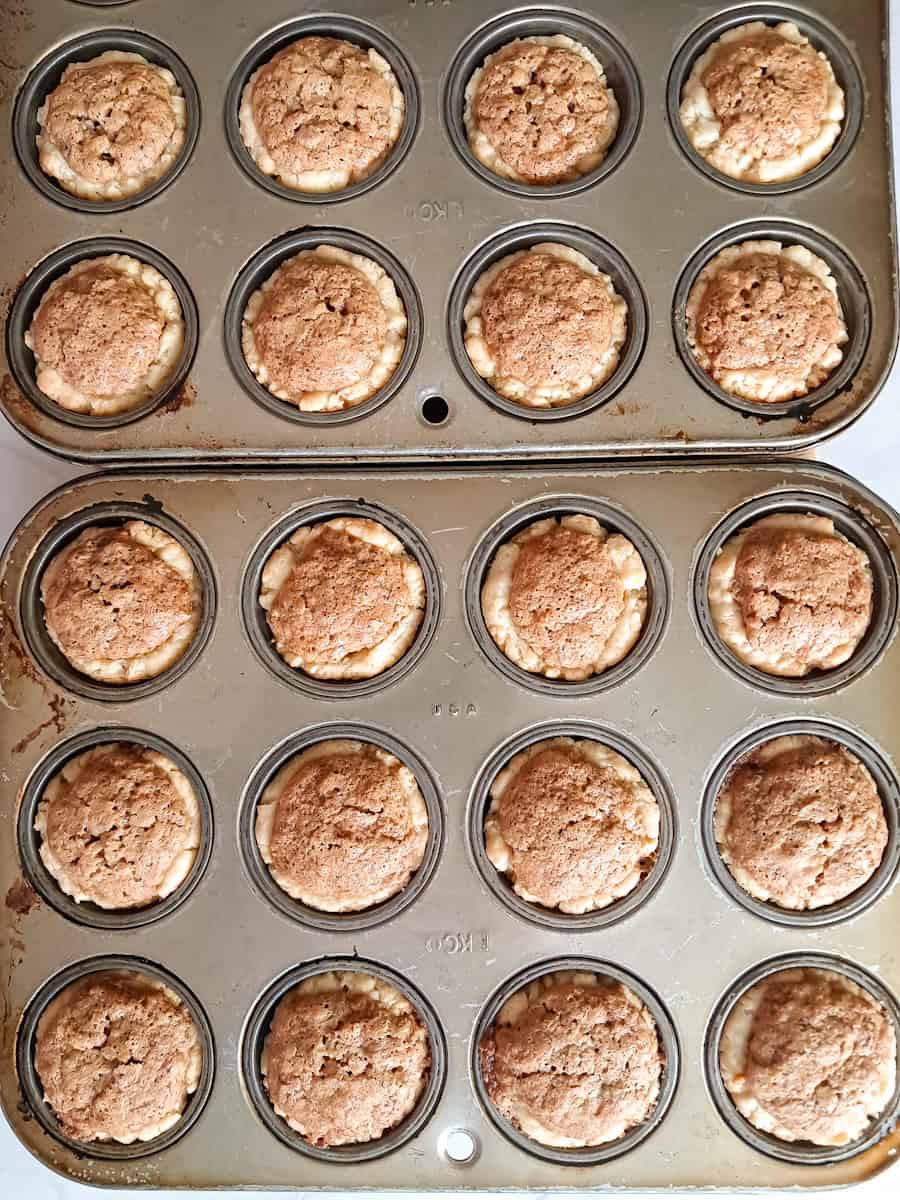 2 muffin tins with baked mini pecan bites.