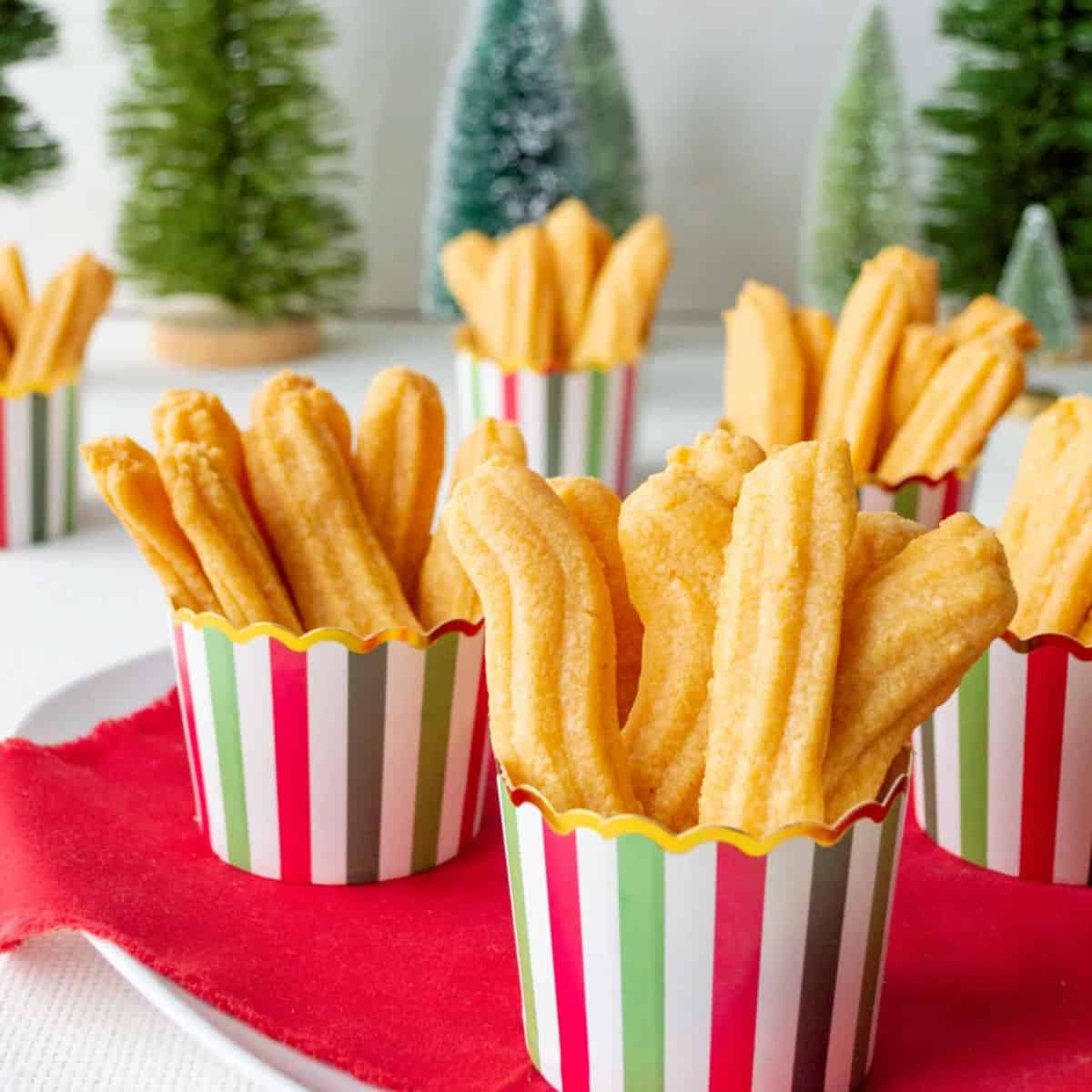 beautiful cups full of homemade cheese straws.