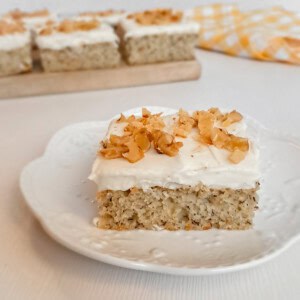 banana nut bar with cream cheese frosting on a small plate.