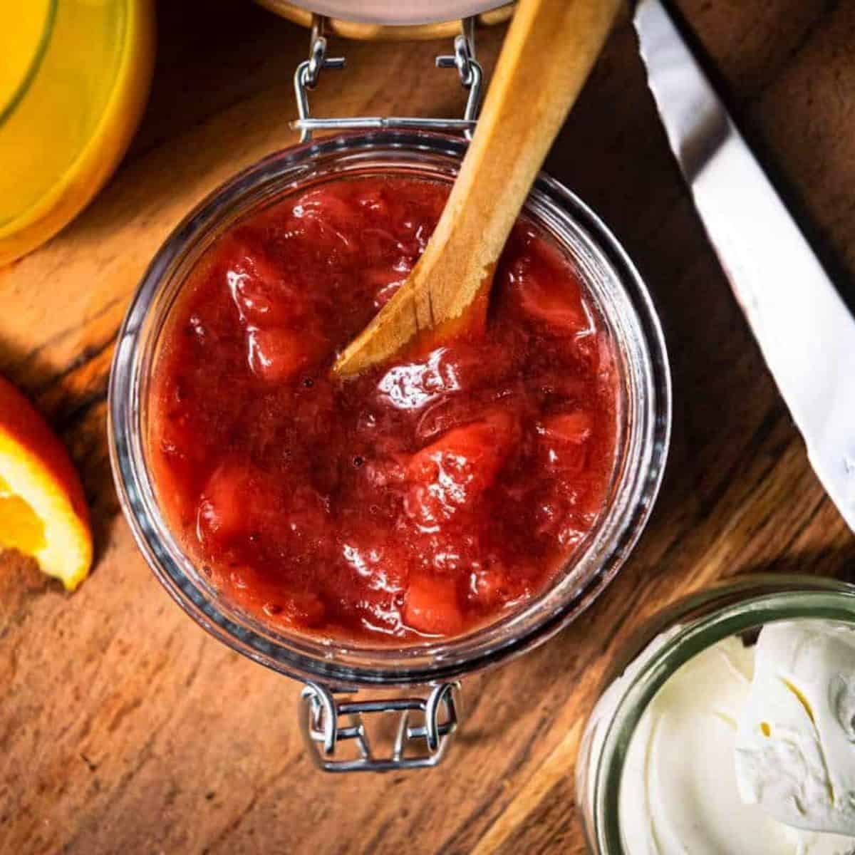 a jar of strawberry compote for serving with angel food cake.