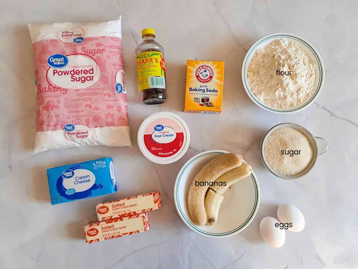 Ingredients: flour, sugar, eggs, bananas, butter, sour cream, cream cheese, baking soda, vanilla, and powdered sugar.