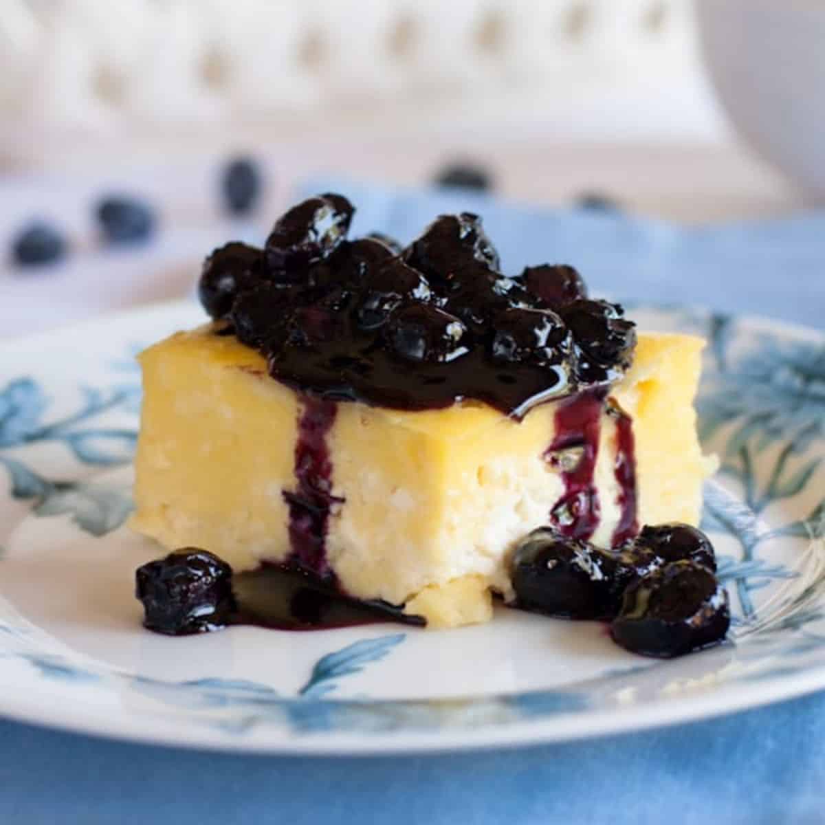 blueberry sauce over a slice of cake.