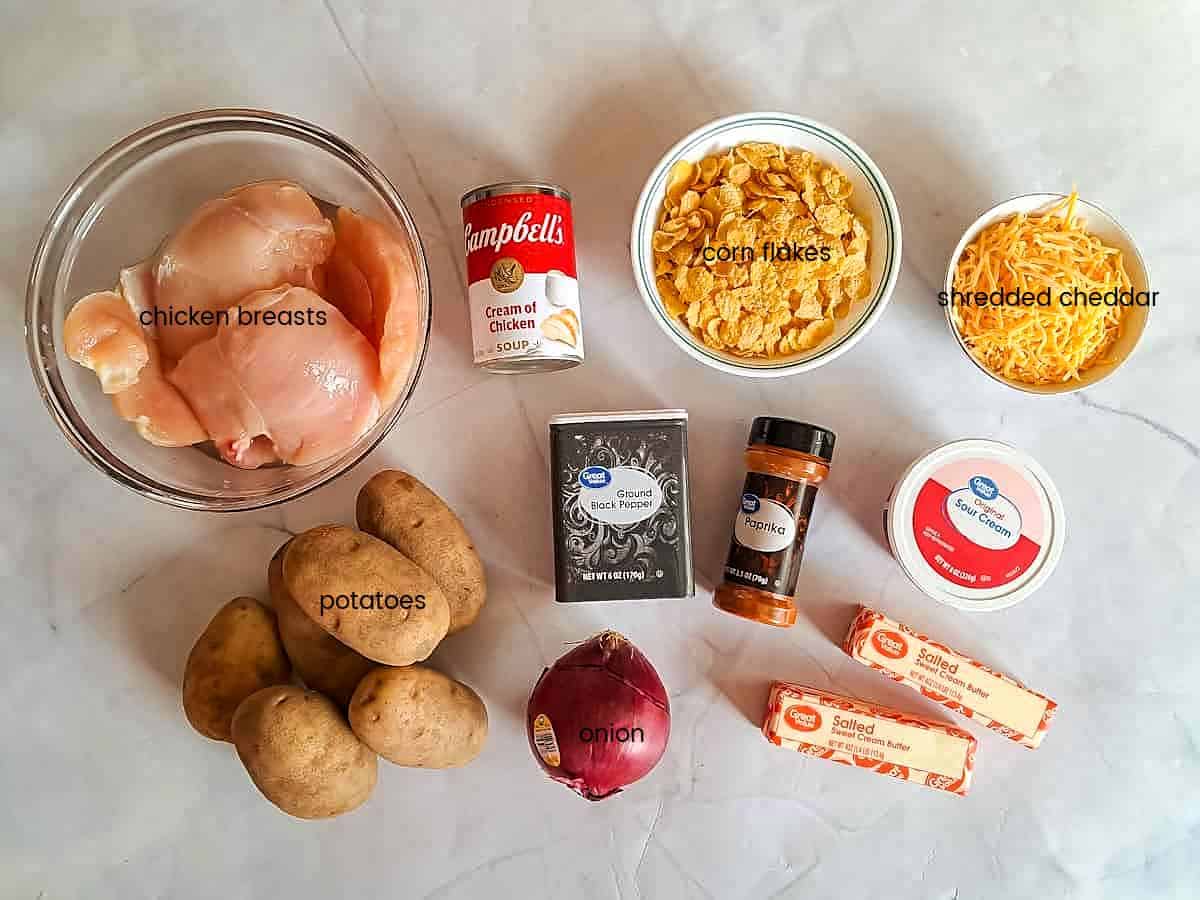 Ingredients: Chicken, potatoes, corn flakes,cream of chicken, butter, sour cream, cheese, black pepper, and paprika.