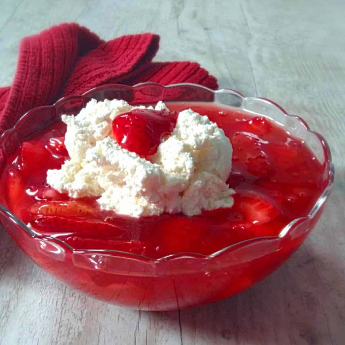 a bowl of strawberry danish dessert topped with whipped cream.