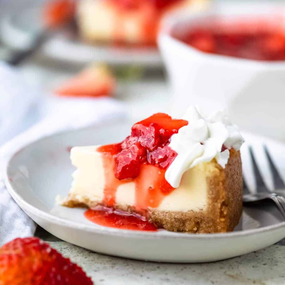 cheesecake on a plate with strawberry topping.