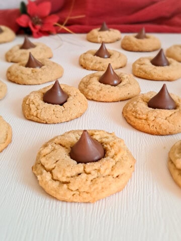 peanut butter blossom cookies scattered around.