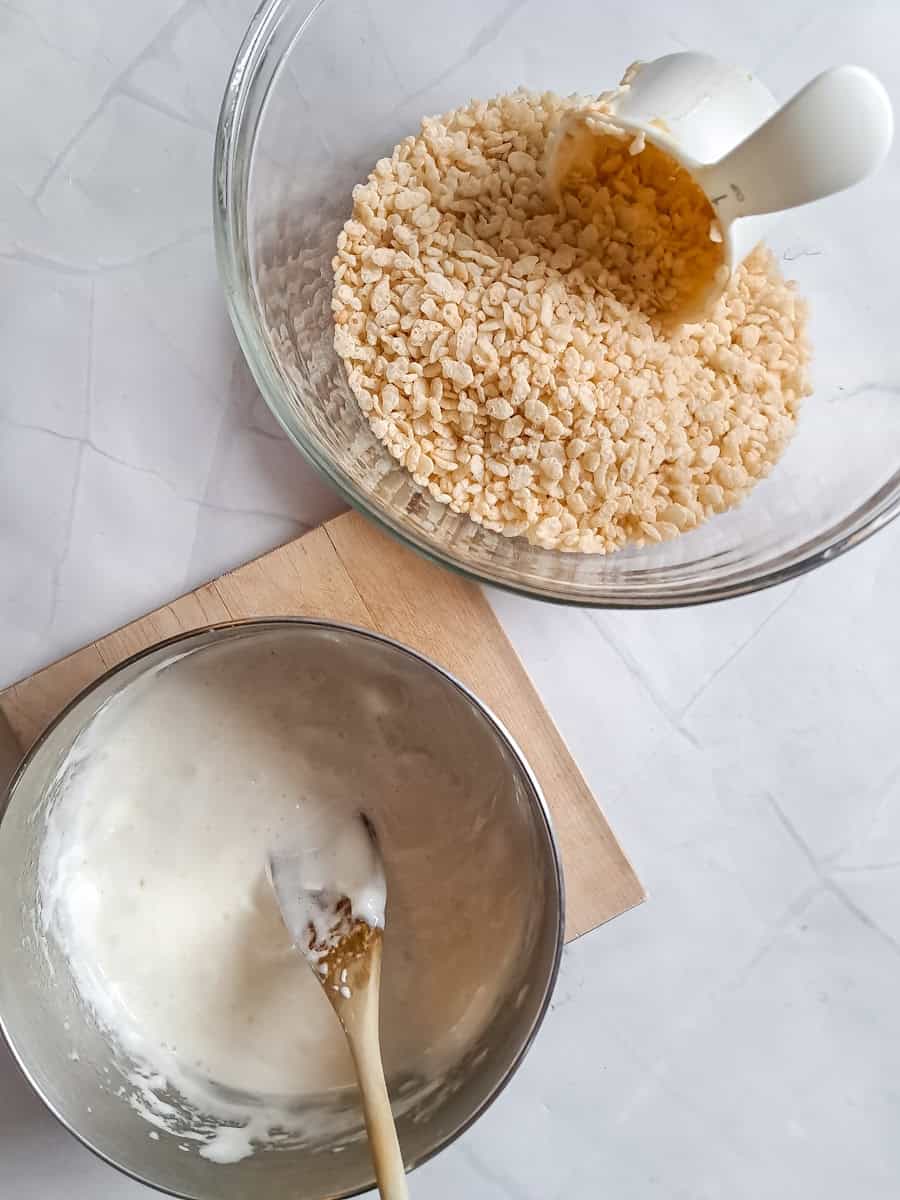 saucepan with melted marshmallows and another bowl with Rice Krispies.