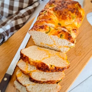 a loaf of Amish jalapeno cheese bread on a board.