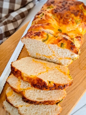 a loaf of Amish jalapeno cheese bread on a board.
