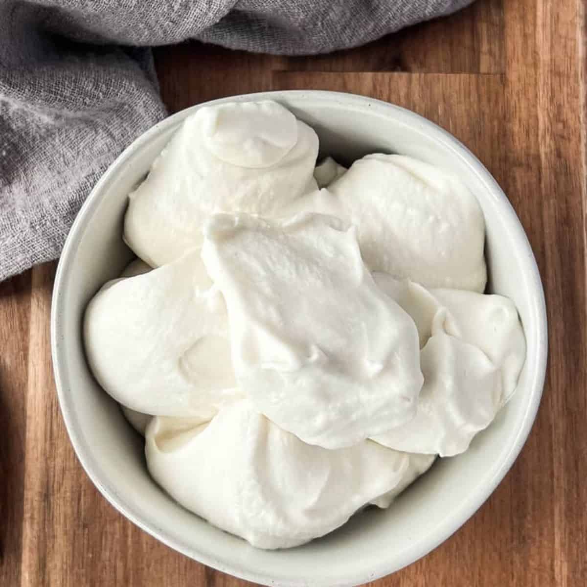 a bowl of fluffy oat milk whipped cream.