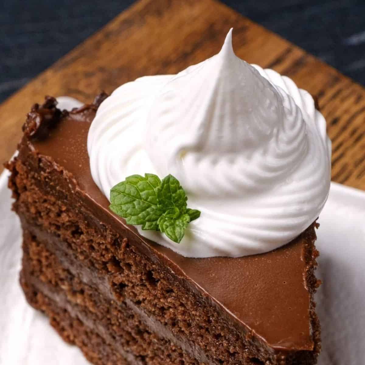 a swirl of whipped cream on top of chocolate cake.