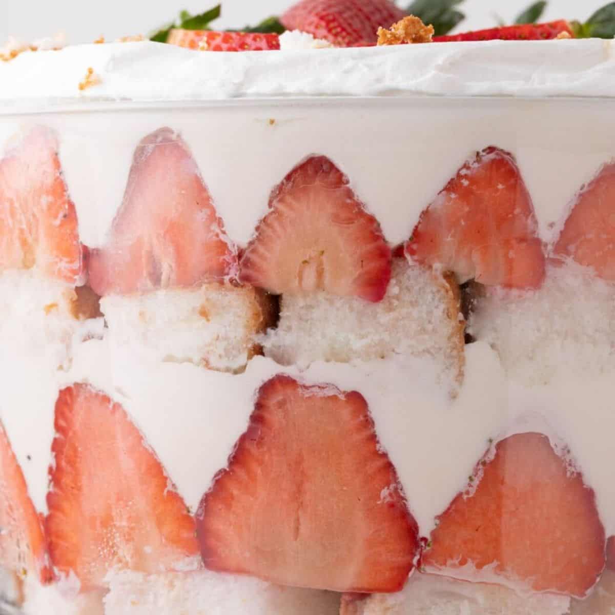 strawberry, angel food cake, and pudding layered in a trifle bowl.