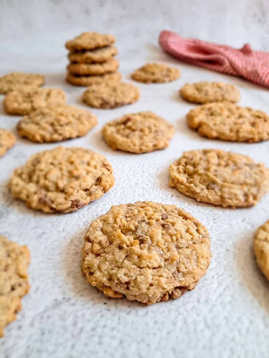 butterscotch crunch cookies on a light background and a stack of cookies in background.