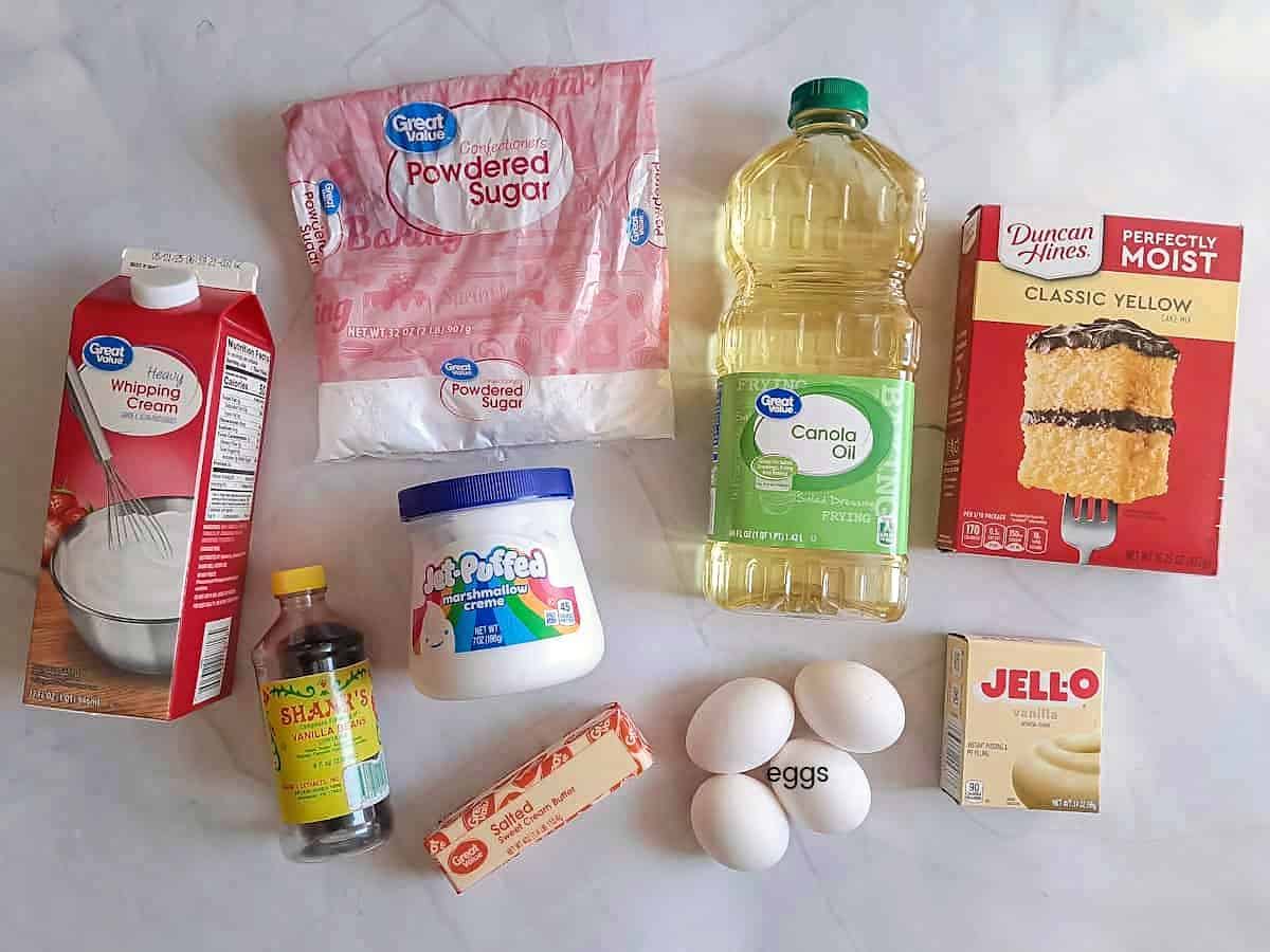 Ingredients: cake mix, instant pudding, eggs, oil, butter, vanilla, powdered sugar, whipping cream, and marshmallow.