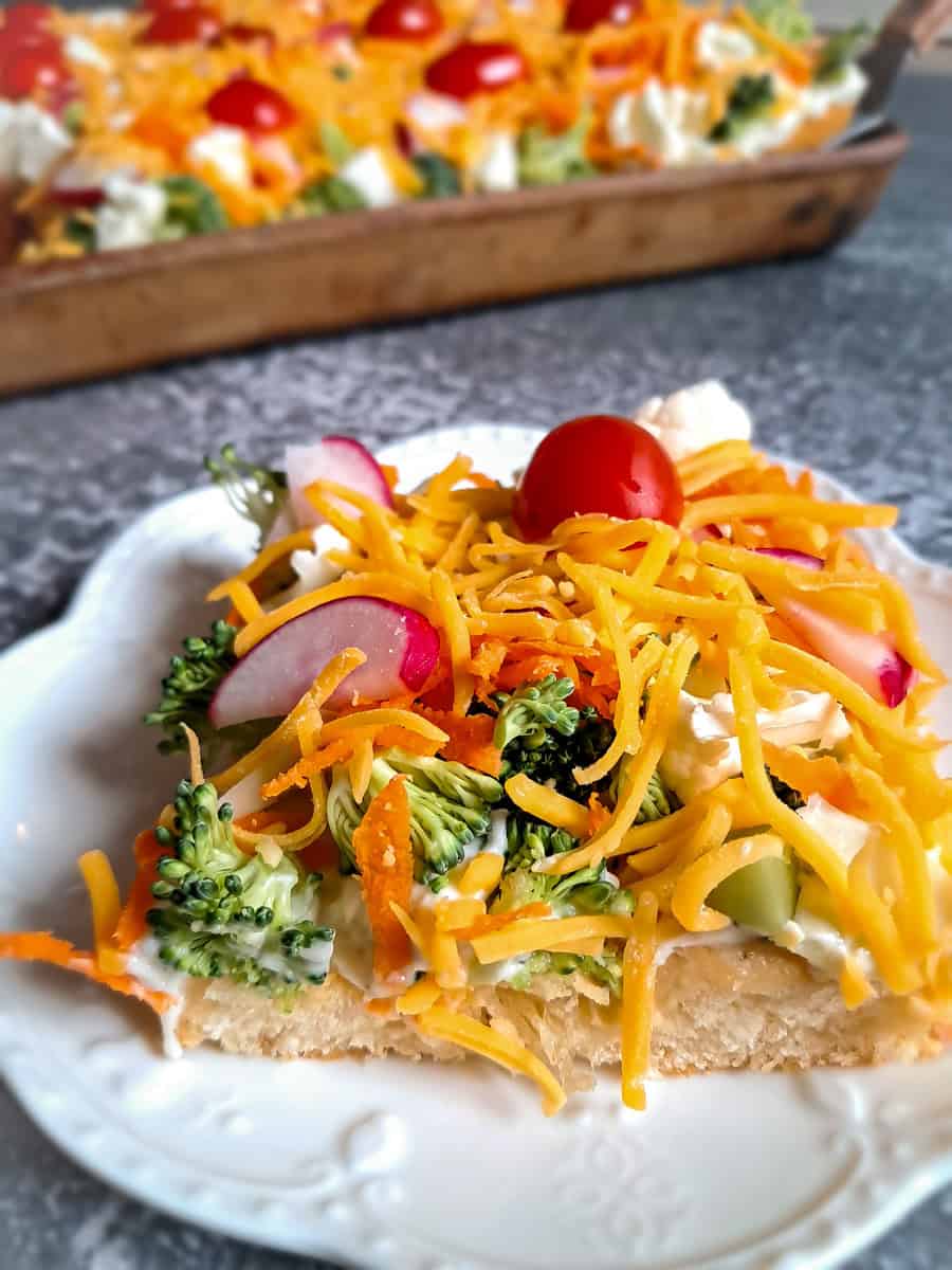close up of a slice of Amish vegetable pizza.