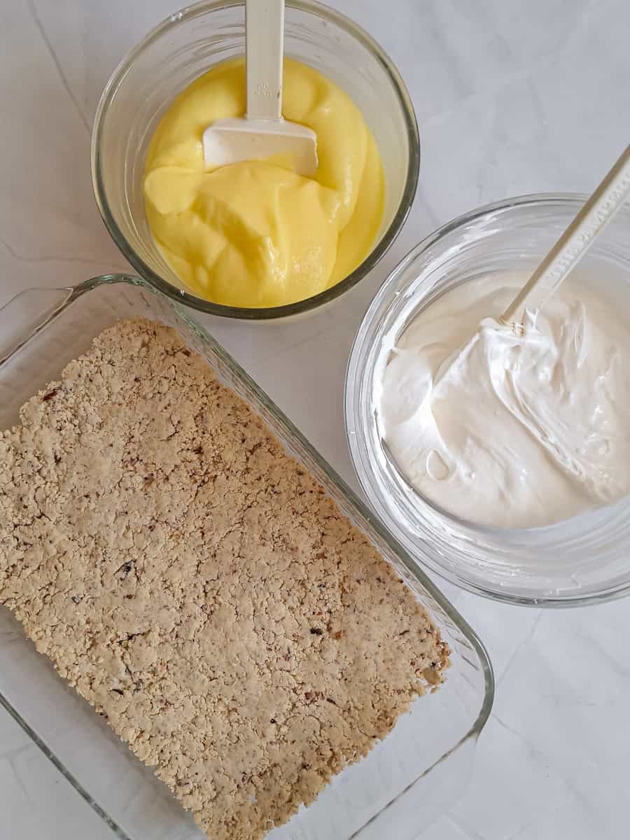 crust in a pan, cream cheese filling in a bowl, pudding in a second bowl.
