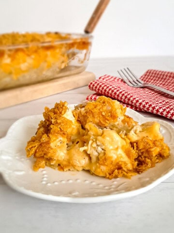9x13" dish of Amish potatoes and chicken casserole and a serving on a small plate.