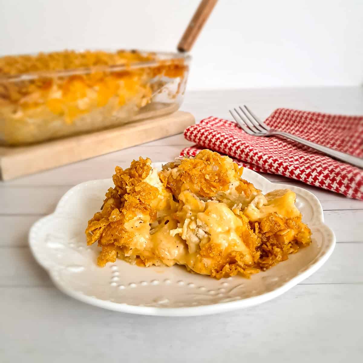 9x13" dish of Amish potatoes and chicken casserole and a serving on a small plate.