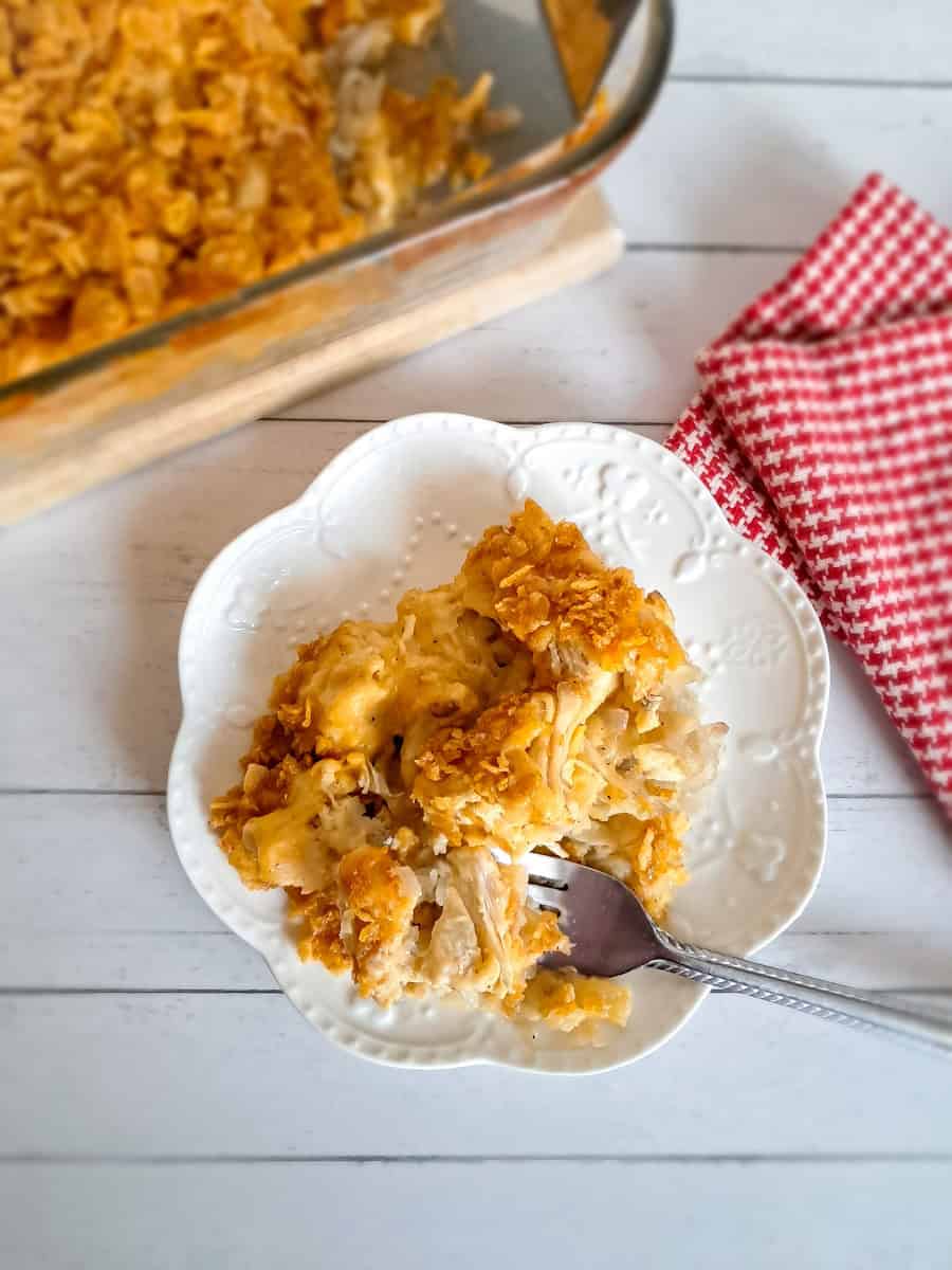 digging a fork into a dish of chicken and potato casserole.