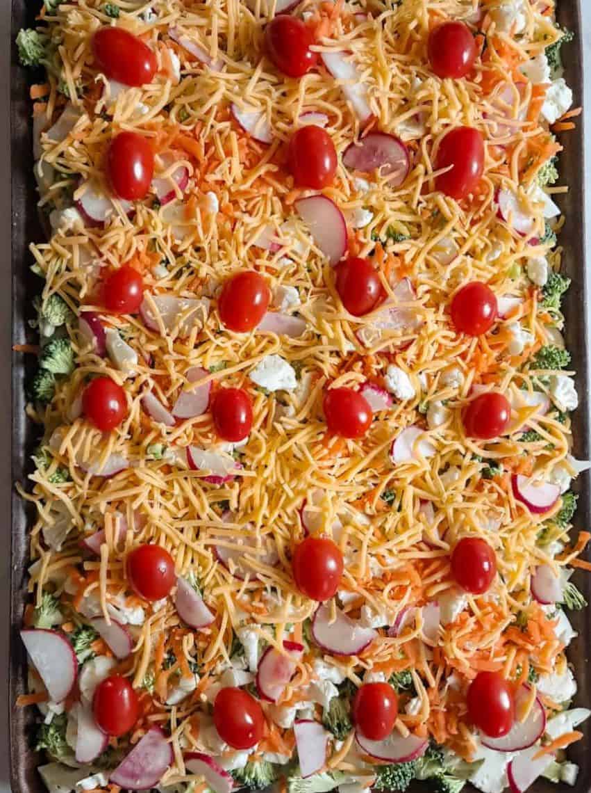 sheet pan full of vegetable pizza topped and ready to eat.