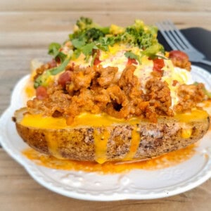 delicious looking baked potato piled with toppings.