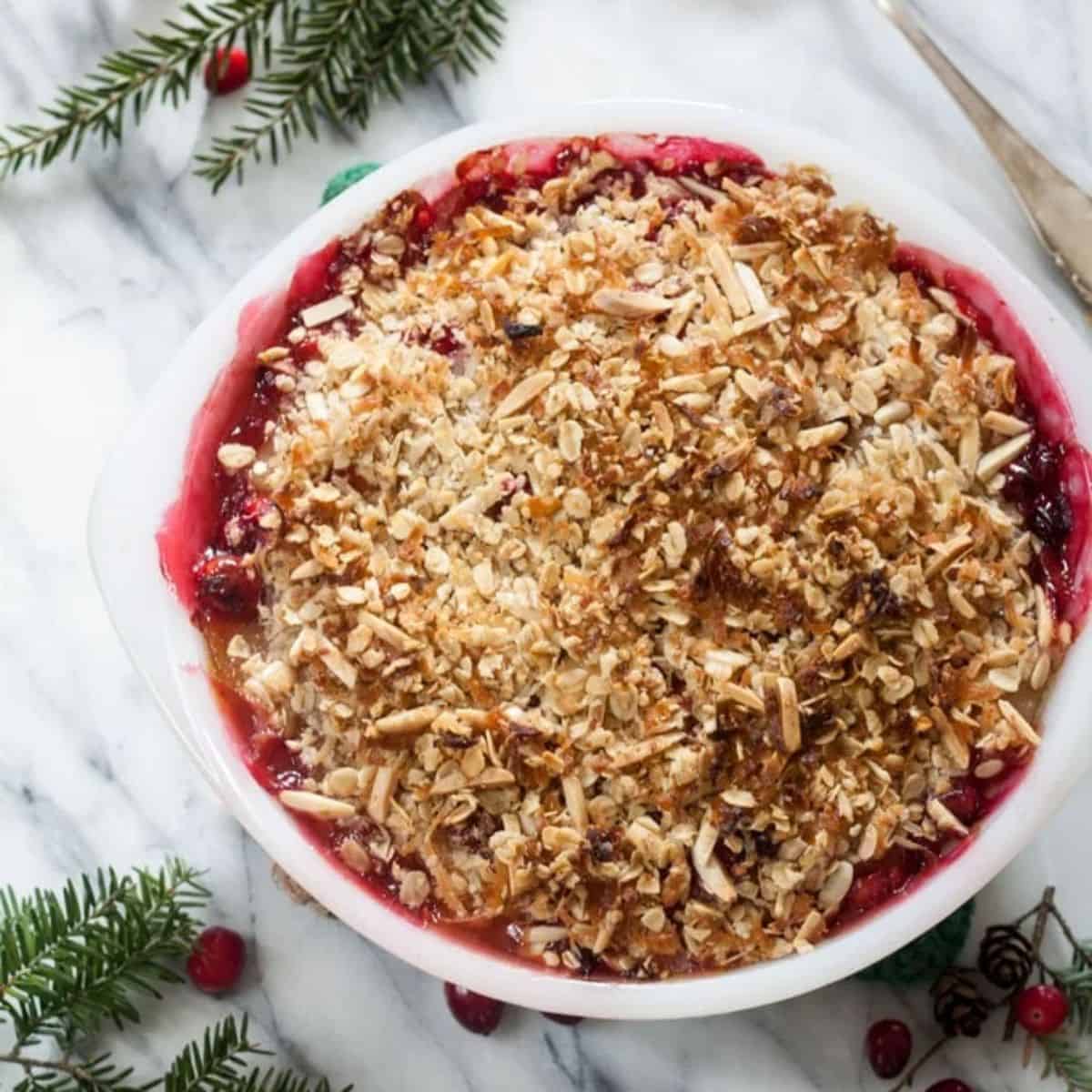 a bowl of apple cranberry crisp.