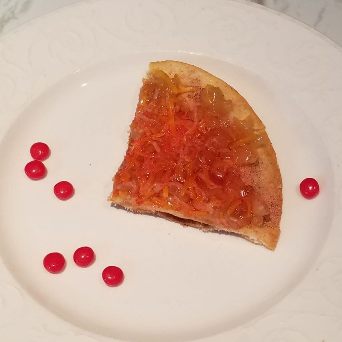 apple grande triangle on a plate with red hots.