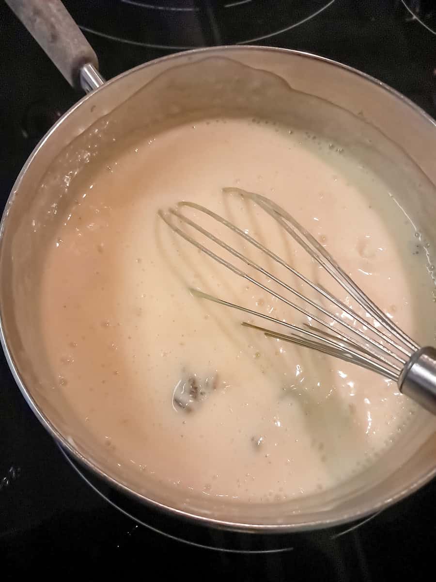 cooking the raisin cream mixture in a saucepan.
