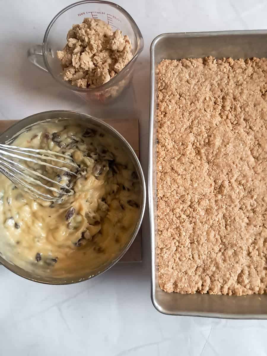 baked crust in pan, cooked raisin filling in saucepan, and reserved crumbs in another dish.
