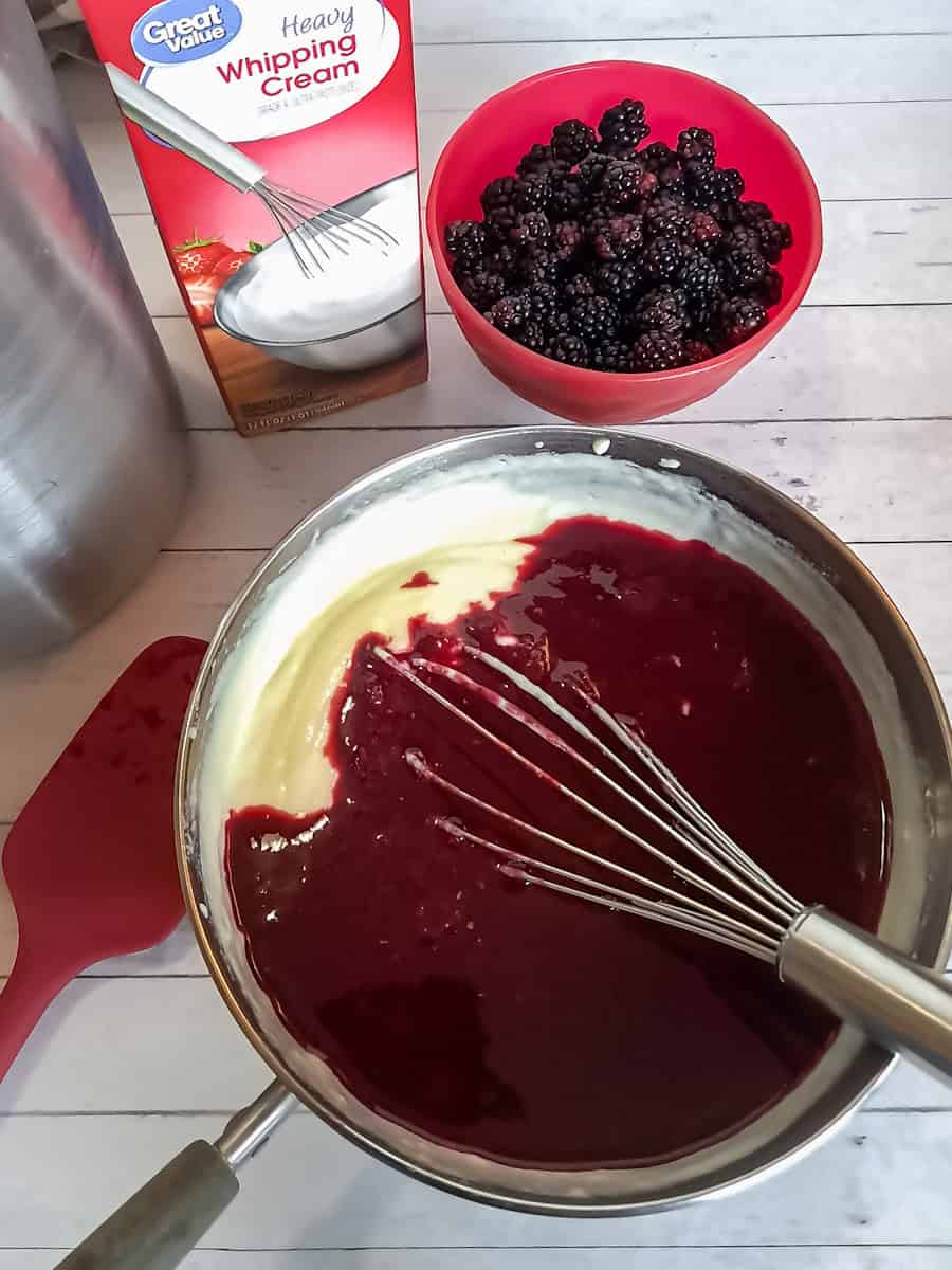 mixing the berry sauce into the custard base.