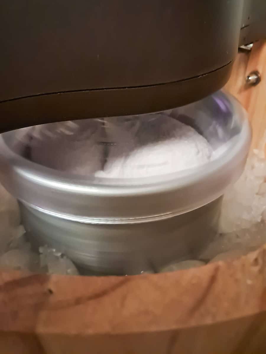 churning homemade ice cream in an old-fashioned ice cream maker.