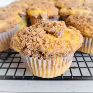 close-up of coffee cake muffins cooling on a wire rack.