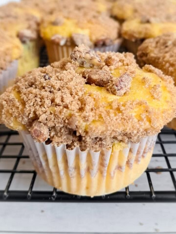 close-up of coffee cake muffins cooling on a wire rack.