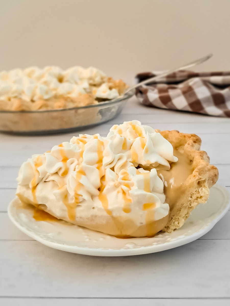 featuring a slice of homemade Amish butterscotch pie with whipped cream topping.