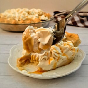 featuring a bite out of a slice of butterscotch cream pie.