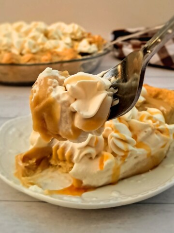 featuring a bite out of a slice of butterscotch cream pie.