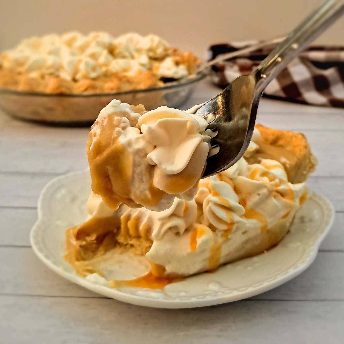 featuring a bite out of a slice of butterscotch cream pie.