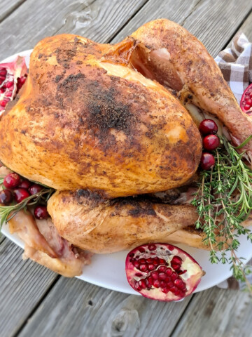 Using an Amish turkey recipe, we have a whole roasted turkey on a large platter.