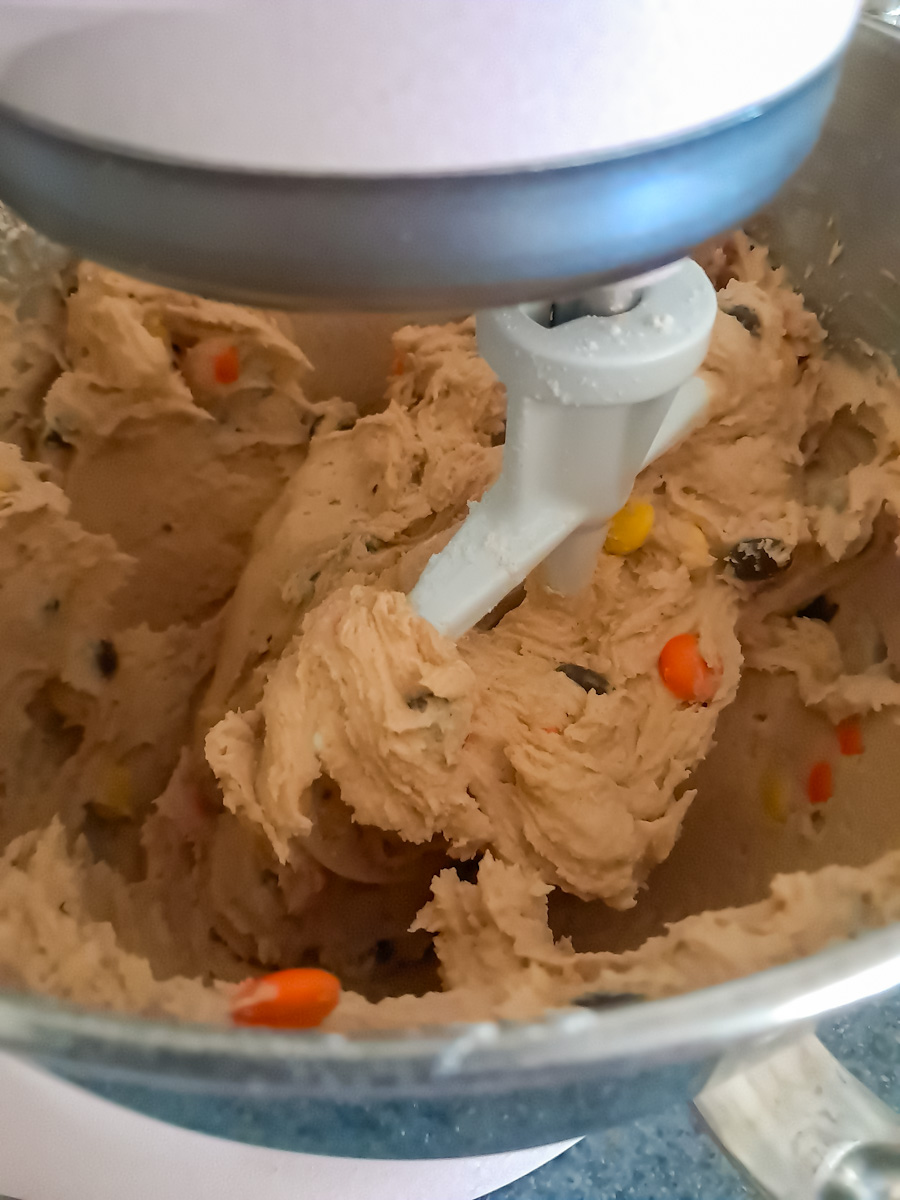 mixing peanut butter cookies in a large mixer.