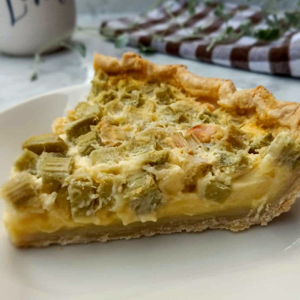 a slice of rhubarb custard pie on a plate.