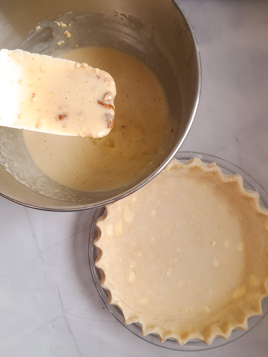 Empty pie crust and liquid mixture in a bowl, ready to assemble our pie.