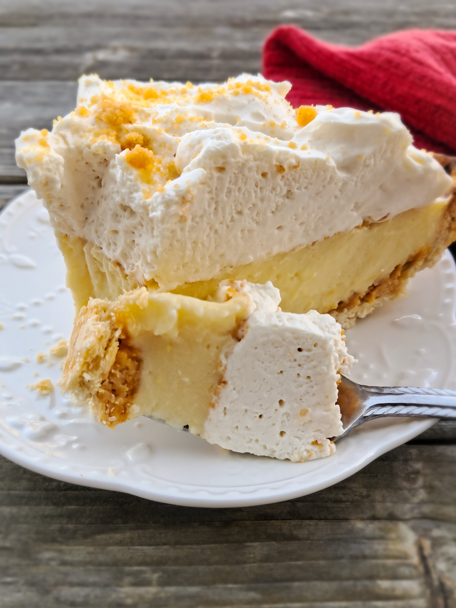 taking a bite of a slice of peanut butter cream pie, giving you an inside look at the beautiful textures.