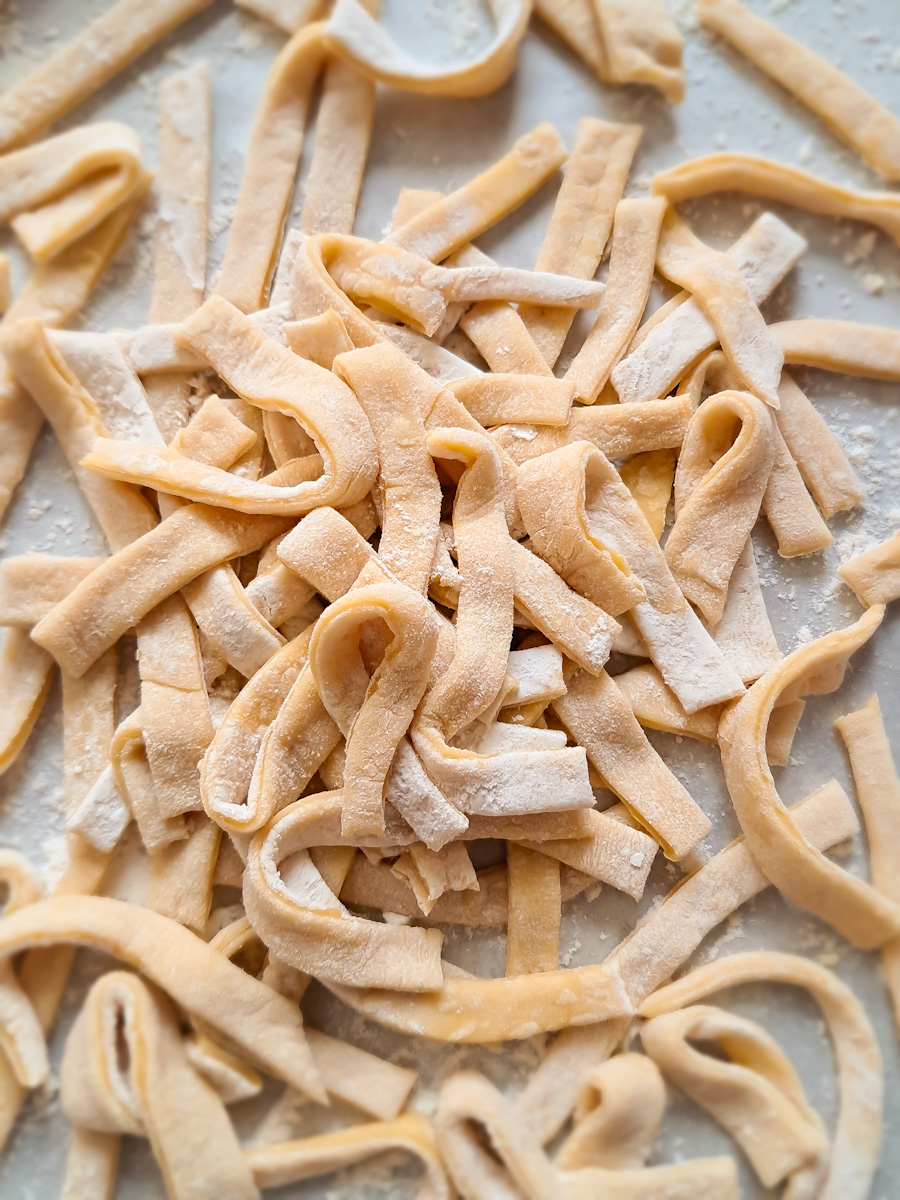 a pile of homemade Amish egg noodles scattered around.