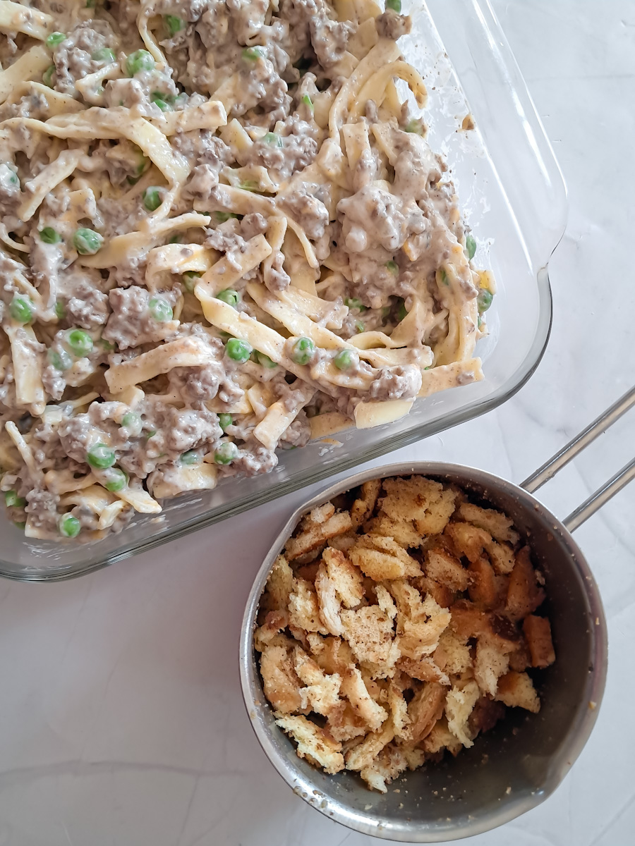 Amish casserole ingredients mixed together and in a pan ready to put the bread crumb topping over the top.