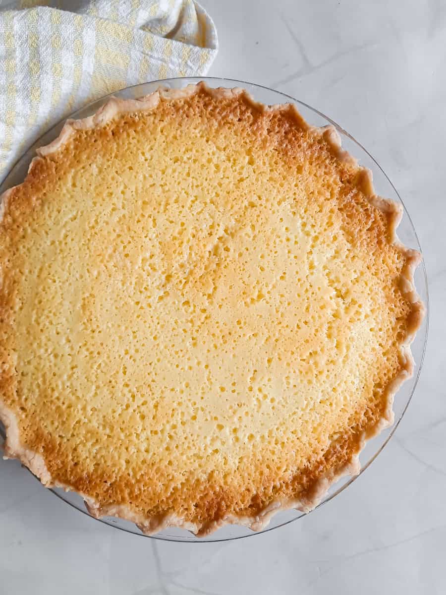 a 9" old-fashioned buttermilk pie ready to be eaten.