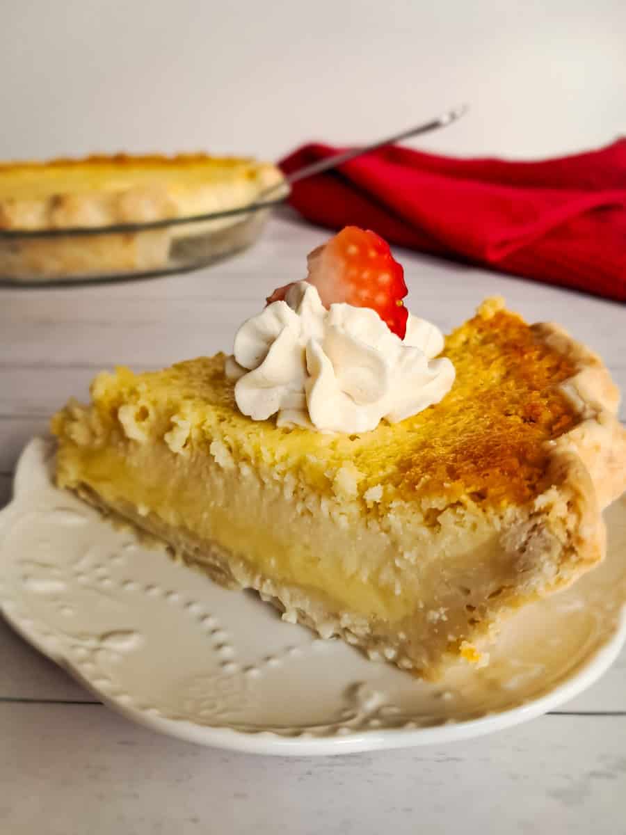 featuring a slice of classic buttermilk pie topped with whipped cream.